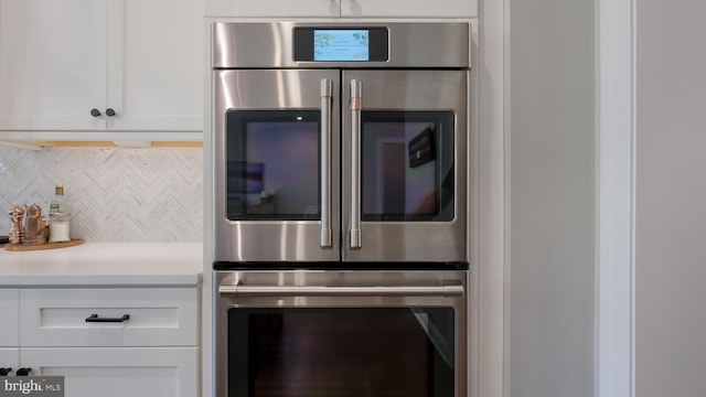 274 W Ashland St, Doylestown, PA 18901 - kitchen with refrigerator, wall oven, tasteful backsplash, white cabinets, and light countertops