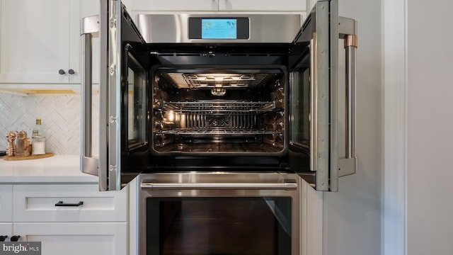 274 W Ashland St, Doylestown, PA 18901 - kitchen view of wine cooler, backsplash, white cabinets, and oven