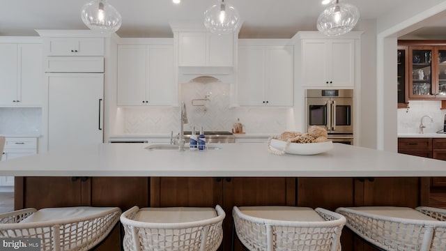 274 W Ashland St, Doylestown, PA 18901 - kitchen with decorative backsplash, double oven, light countertops, and white cabinetry