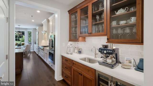 274 W Ashland St, Doylestown, PA 18901 - kitchen with brown cabinetry, dark wood finished floors, backsplash, light countertops, and recessed lighting