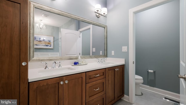 274 W Ashland St, Doylestown, PA 18901 - bathroom with double vanity, tile patterned floors, and a chandelier