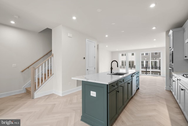 23079 Copper Tree Ter, Ashburn, VA 20148 - kitchen featuring a center island with sink, recessed lighting, stainless steel appliances, french doors, and light stone countertops