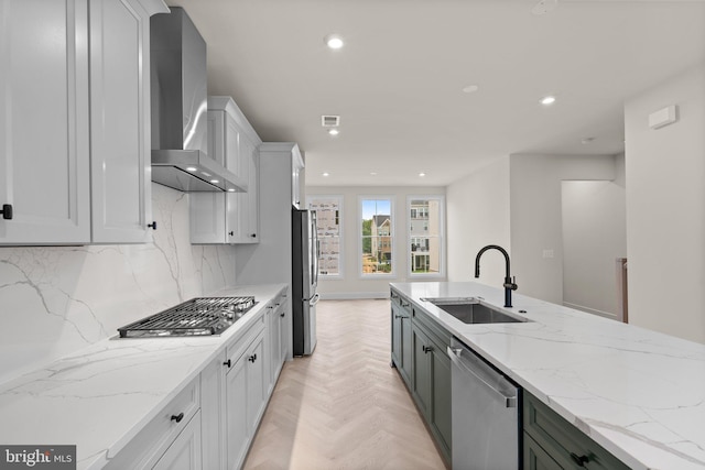 23079 Copper Tree Ter, Ashburn, VA 20148 - kitchen featuring wall chimney exhaust hood, appliances with stainless steel finishes, recessed lighting, tasteful backsplash, and light stone counters