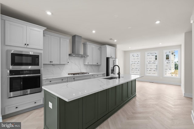 23079 Copper Tree Ter, Ashburn, VA 20148 - kitchen featuring stainless steel appliances, wall chimney range hood, a large island, tasteful backsplash, and recessed lighting