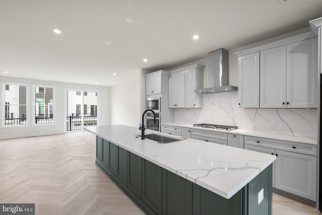 23079 Copper Tree Ter, Ashburn, VA 20148 - kitchen featuring wall chimney range hood, a center island with sink, stainless steel gas stovetop, built in microwave, and recessed lighting