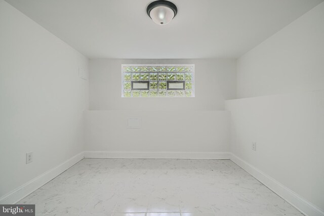3522 Ellerslie Ave, Baltimore, MD 21218 - empty room with marble look tile flooring and baseboards
