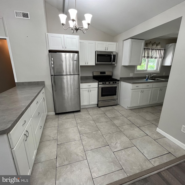 14 Akwaala Trl, Browns Mills, NJ 08015 - kitchen with stainless steel appliances, vaulted ceiling, dark countertops, a chandelier, and white cabinets