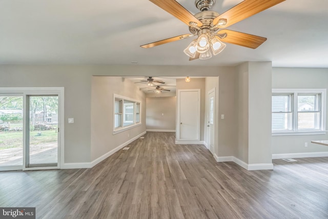 511 Sylvan Way, Pasadena, MD 21122 - unfurnished living room featuring plenty of natural light, a ceiling fan, and wood finished floors