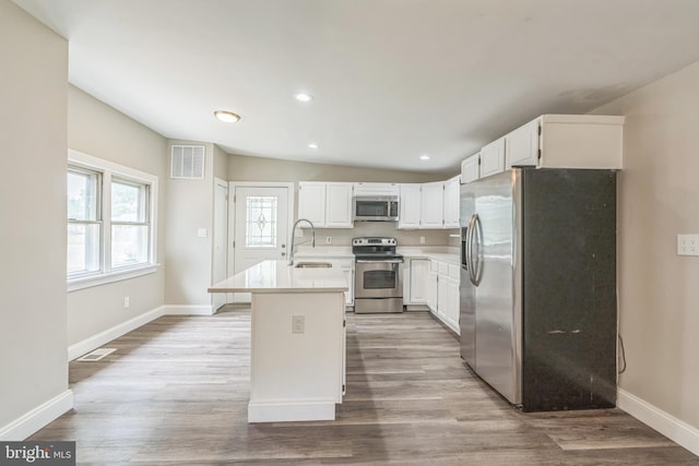 511 Sylvan Way, Pasadena, MD 21122 - kitchen featuring appliances with stainless steel finishes, light wood-type flooring, white cabinetry, light countertops, and recessed lighting