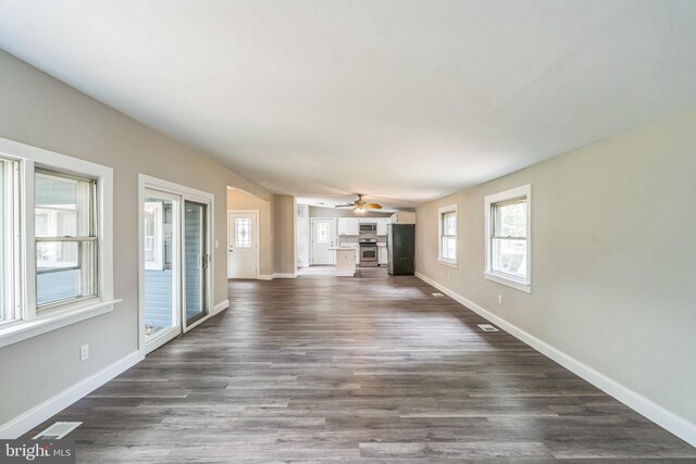 511 Sylvan Way, Pasadena, MD 21122 - unfurnished living room with ceiling fan and dark wood-style flooring