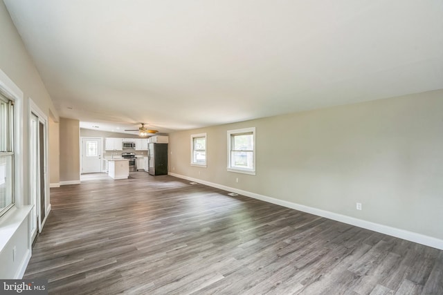 511 Sylvan Way, Pasadena, MD 21122 - unfurnished living room with dark wood-style flooring and a ceiling fan