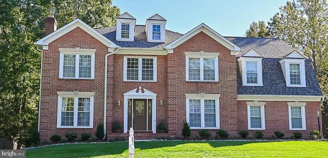 10115 Homar Pond Dr, Fairfax Station, VA 22039 - view of front of house featuring a chimney, a front yard, brick siding, and a shingled roof