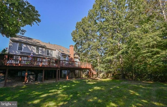 10115 Homar Pond Dr, Fairfax Station, VA 22039 - back of house with a wooden deck, stairway, a lawn, and a chimney