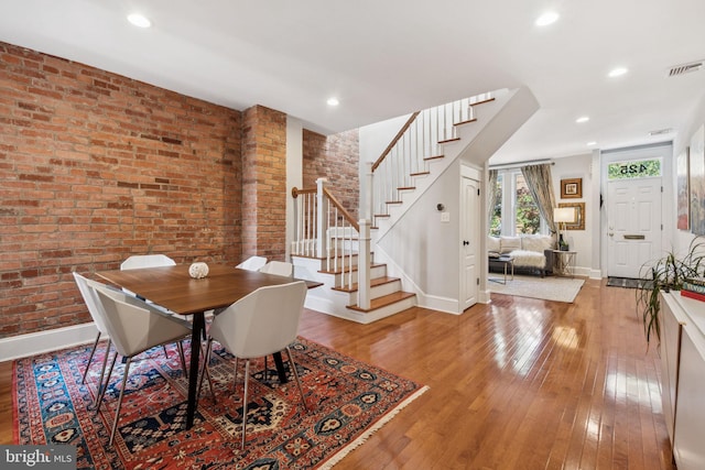 425 16th St SE, Washington, DC 20003 - dining room featuring stairs, light wood-type flooring, brick wall, and recessed lighting