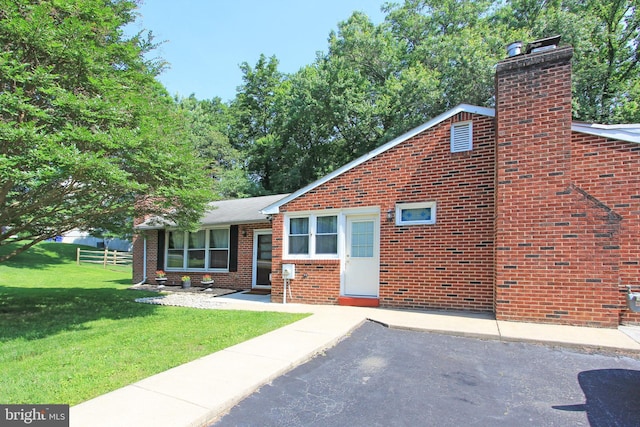 311 Norman Dr, Newark, DE 19702 - view of front of home with a chimney and brick siding