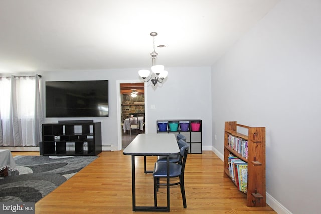311 Norman Dr, Newark, DE 19702 - dining area with a baseboard radiator, a chandelier, and wood finished floors