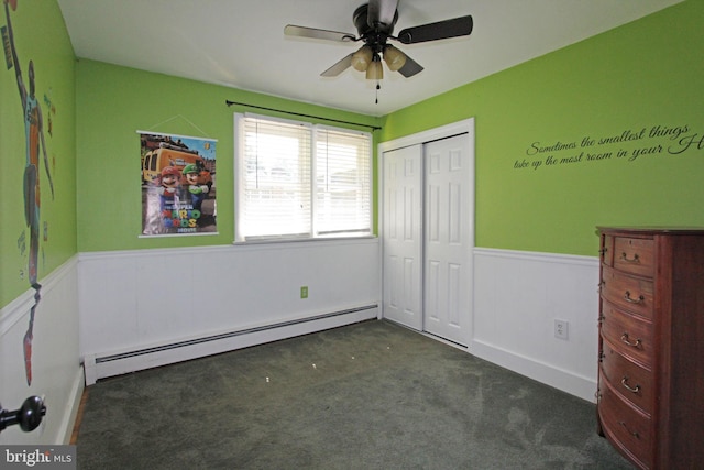 311 Norman Dr, Newark, DE 19702 - unfurnished bedroom featuring baseboard heating, wainscoting, carpet, a closet, and a ceiling fan