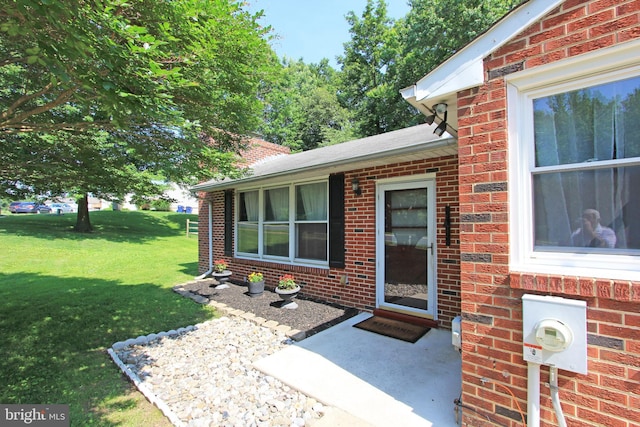 311 Norman Dr, Newark, DE 19702 - view of exterior entry with brick siding and a lawn