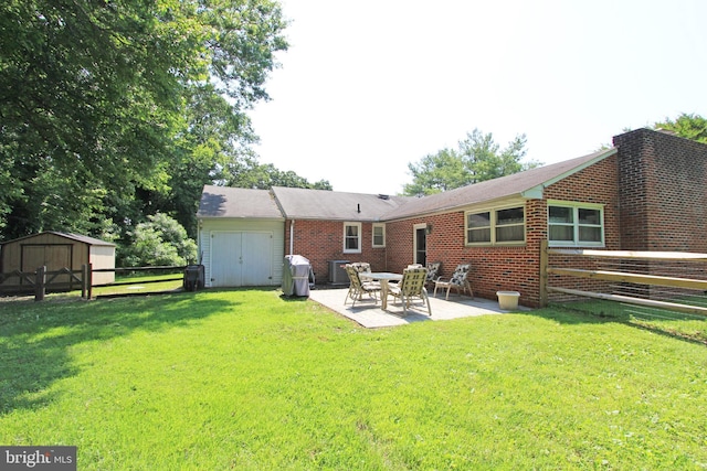 311 Norman Dr, Newark, DE 19702 - back of property with a shed, a patio area, and brick siding