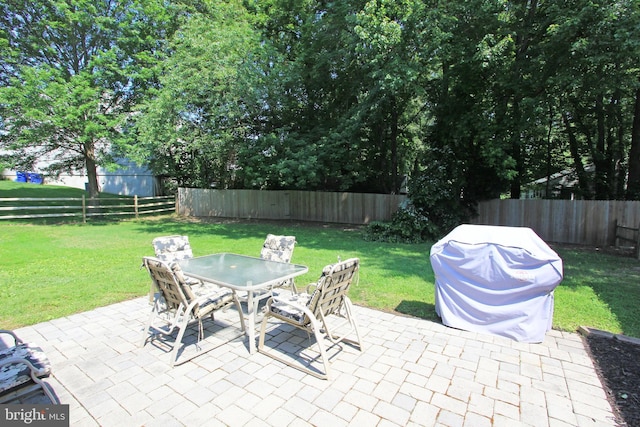 311 Norman Dr, Newark, DE 19702 - fenced backyard featuring outdoor dining space, a patio, and area for grilling