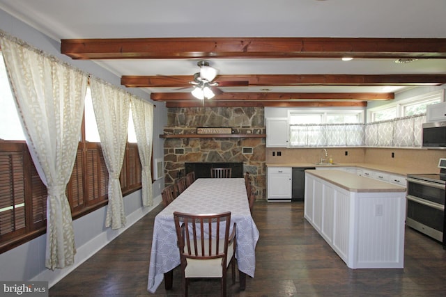 311 Norman Dr, Newark, DE 19702 - kitchen featuring appliances with stainless steel finishes, light countertops, white cabinets, dark wood-style flooring, and beam ceiling
