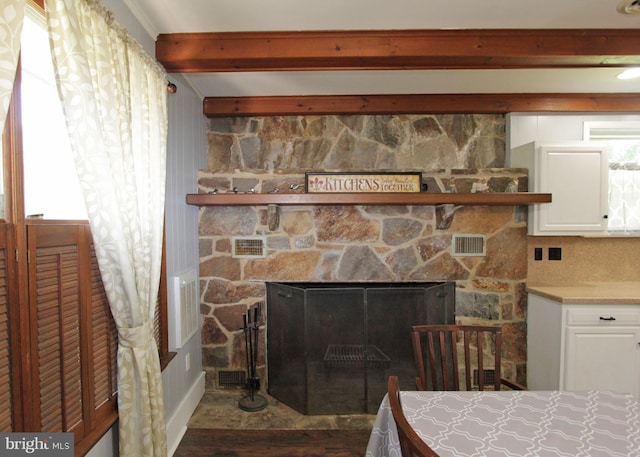 311 Norman Dr, Newark, DE 19702 - detailed view of beamed ceiling, a fireplace, and wood finished floors