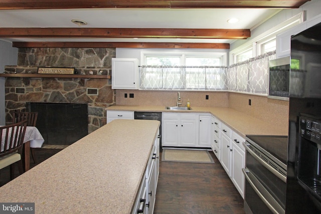 311 Norman Dr, Newark, DE 19702 - kitchen featuring appliances with stainless steel finishes, beam ceiling, dark wood-style flooring, white cabinetry, and light countertops