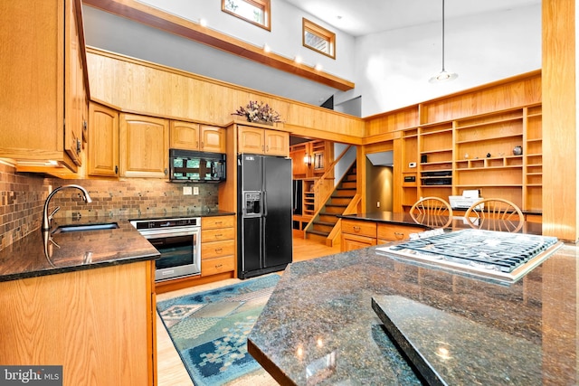 46 Grassy Lake Rd, Shamong, NJ 08088 - kitchen featuring black appliances, a towering ceiling, backsplash, light wood-style flooring, and dark stone countertops