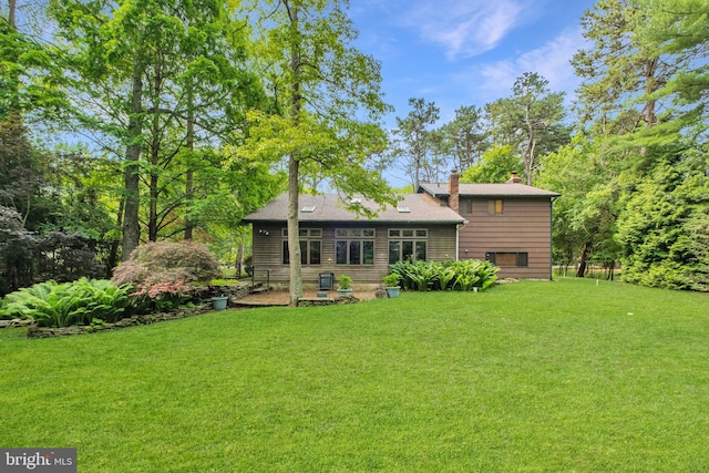 46 Grassy Lake Rd, Shamong, NJ 08088 - back of house featuring a chimney, a yard, and a patio