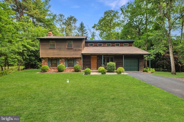 46 Grassy Lake Rd, Shamong, NJ 08088 - view of front of property with a chimney, a front yard, asphalt driveway, covered porch, and an attached garage