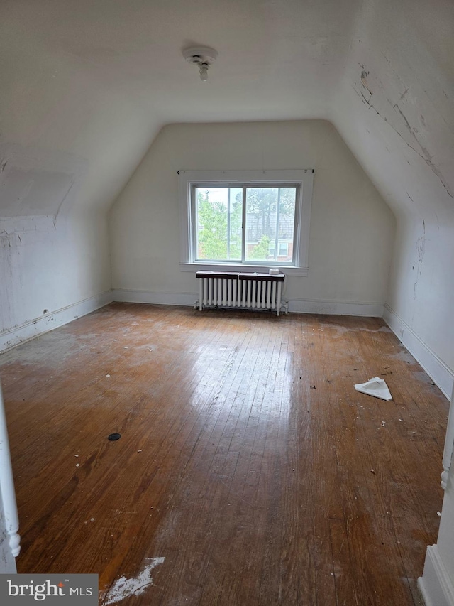 834 N Woodington Rd, Baltimore, MD 21229 - bonus room featuring radiator, vaulted ceiling, and hardwood / wood-style floors