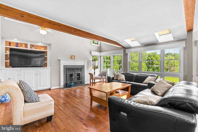 3773 Plum Hill Ct, Ellicott City, MD 21042 - living room with healthy amount of natural light, a skylight, wood finished floors, lofted ceiling, and a fireplace
