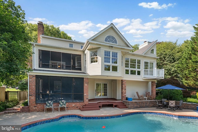 3773 Plum Hill Ct, Ellicott City, MD 21042 - back of house featuring a patio, a chimney, a sunroom, brick siding, and a balcony