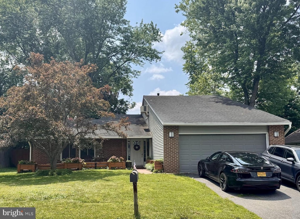 816 Sugarland Run Dr, Sterling, VA 20164 - view of front of home featuring brick siding, asphalt driveway, an attached garage, a front yard, and a shingled roof