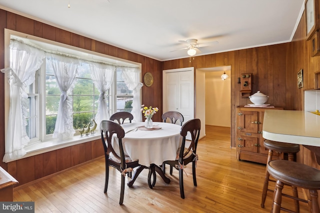 1606 Peacock Ln, Silver Spring, MD 20904 - dining space featuring wooden walls, ceiling fan, ornamental molding, and light wood-style flooring