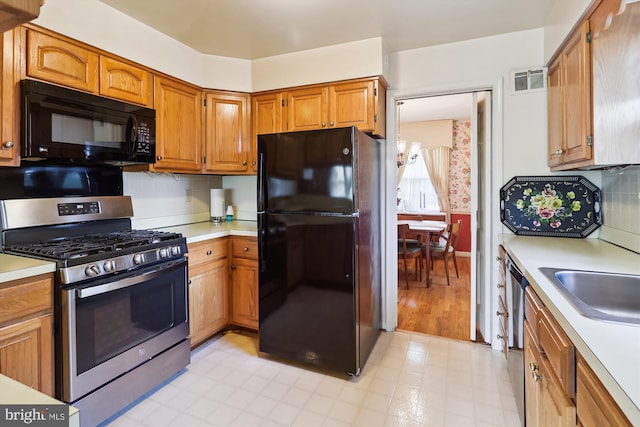 1606 Peacock Ln, Silver Spring, MD 20904 - kitchen with black appliances, light countertops, light floors, and brown cabinets