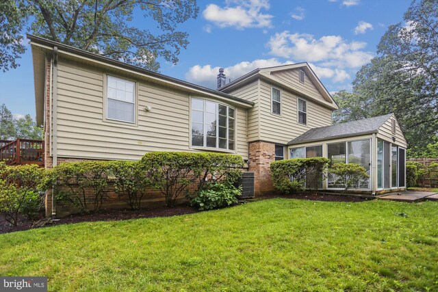 1606 Peacock Ln, Silver Spring, MD 20904 - back of property featuring a sunroom, a lawn, and brick siding
