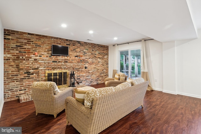 1606 Peacock Ln, Silver Spring, MD 20904 - living room featuring a fireplace, wood finished floors, brick wall, and recessed lighting