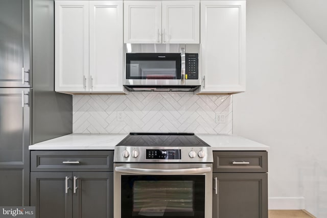 1835 Dudley St, Philadelphia, PA 19145 - kitchen with stainless steel appliances, gray cabinets, tasteful backsplash, and white cabinetry