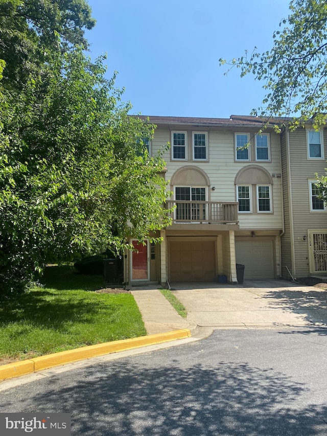 14758 Wexhall Ter Unit 24-261, Burtonsville, MD 20866 - view of front of house with an attached garage, driveway, and a front lawn