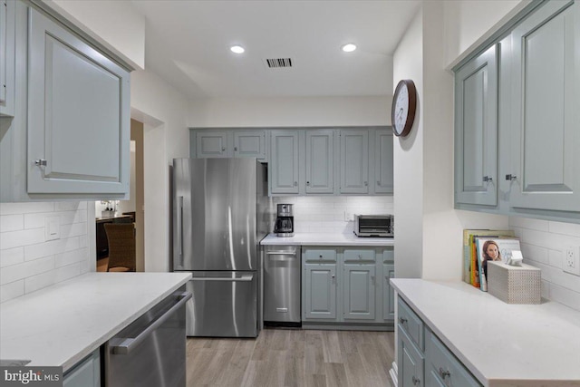 8101 Connecticut Ave Unit N-102, Chevy Chase, MD 20815 - kitchen featuring stainless steel appliances, backsplash, light countertops, and recessed lighting