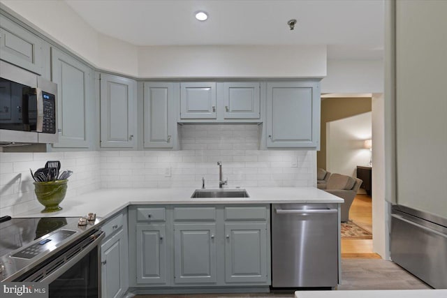 8101 Connecticut Ave Unit N-102, Chevy Chase, MD 20815 - kitchen with stainless steel appliances, gray cabinets, tasteful backsplash, and light countertops