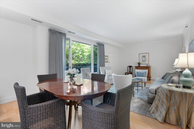 8101 Connecticut Ave Unit N-102, Chevy Chase, MD 20815 - dining space with crown molding and light wood-style flooring