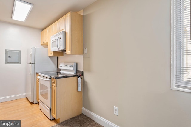 1009 Chillum Rd Unit 305, Hyattsville, MD 20782 - kitchen with white appliances, electric panel, light brown cabinets, dark countertops, and plenty of natural light