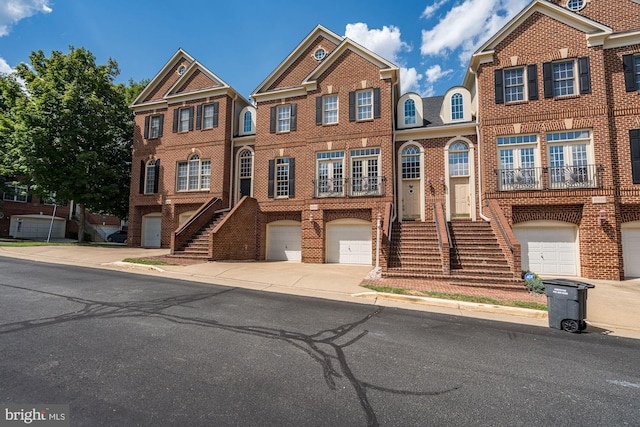47834 Scotsborough Sq, Potomac Falls, VA 20165 - view of front of home with brick siding, a garage, stairway, and driveway