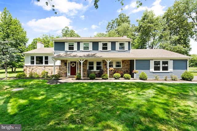 126 Woodview Dr, Doylestown, PA 18901 - view of front of house with a chimney, a front yard, covered porch, and stone siding