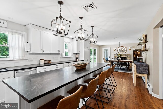 126 Woodview Dr, Doylestown, PA 18901 - kitchen featuring a chandelier, dark countertops, tasteful backsplash, and white cabinets