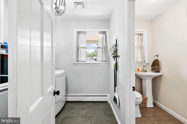 126 Woodview Dr, Doylestown, PA 18901 - bathroom featuring a baseboard heating unit, tile patterned flooring, and separate washer and dryer