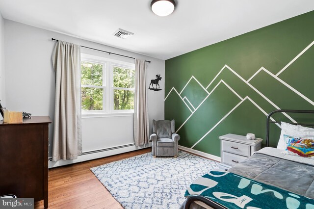 126 Woodview Dr, Doylestown, PA 18901 - bedroom featuring wood finished floors and a baseboard radiator