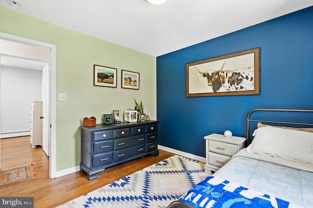 126 Woodview Dr, Doylestown, PA 18901 - bedroom with wood finished floors and a baseboard radiator